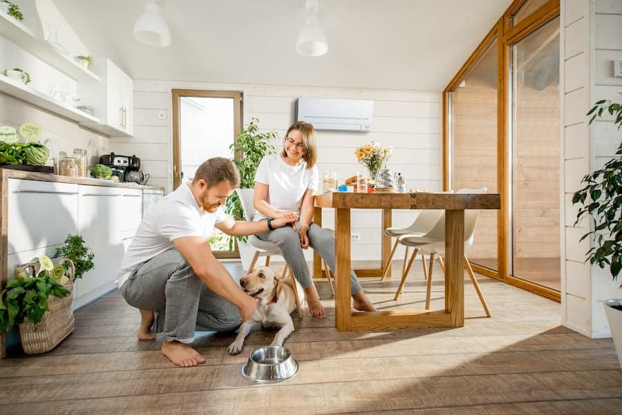 Wall-mounted split system blending into a bright modern kitchen and dining space