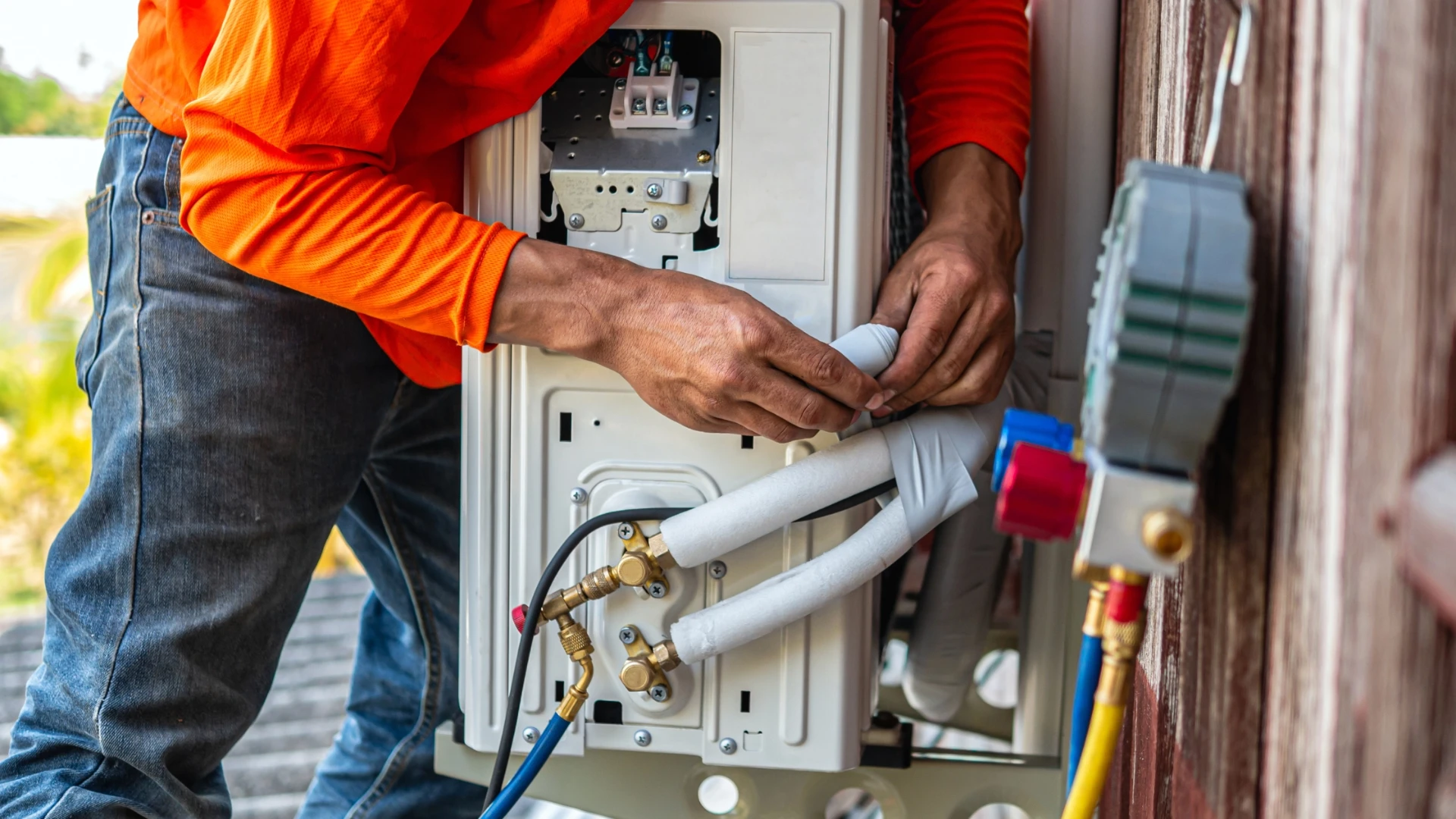 Grotec technician wiring up an outdoor air conditioning unit during installation